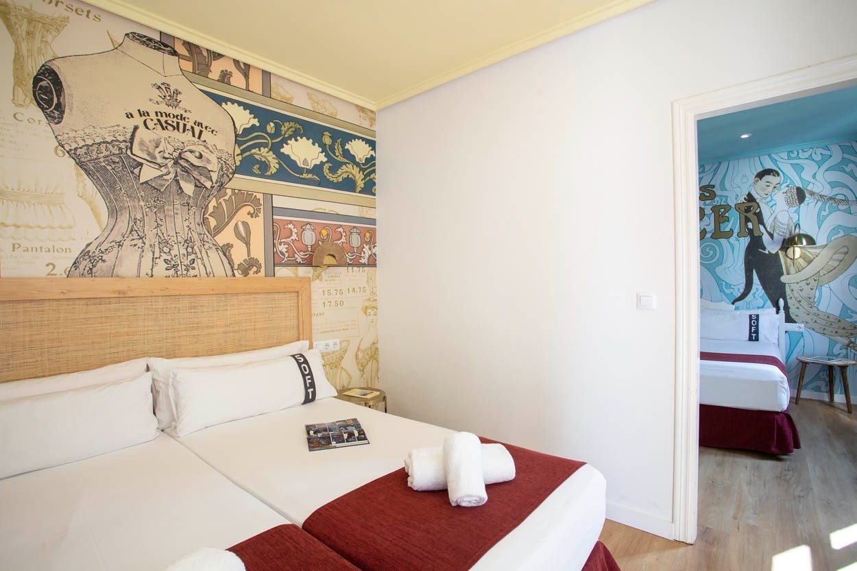 Habitación con dos camas y mural de moda vintage en Casual Vintage Valencia - Hotel céntrico.
