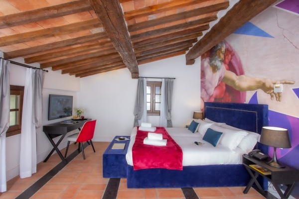 a hotel room with a painting of jesus on the wall