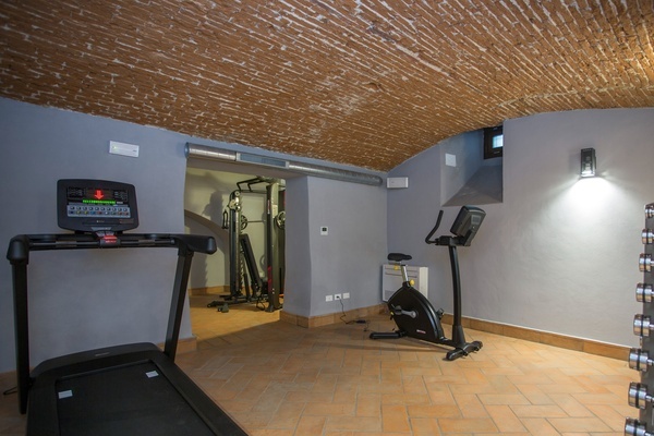 a gym with a treadmill and an exercise bike