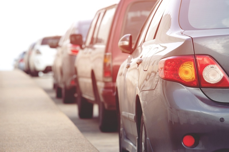 a row of cars are parked on the side of the road