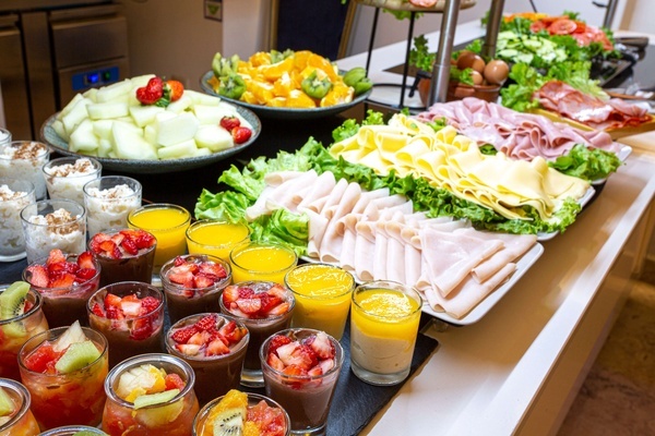 a buffet table with a variety of fruits and juices