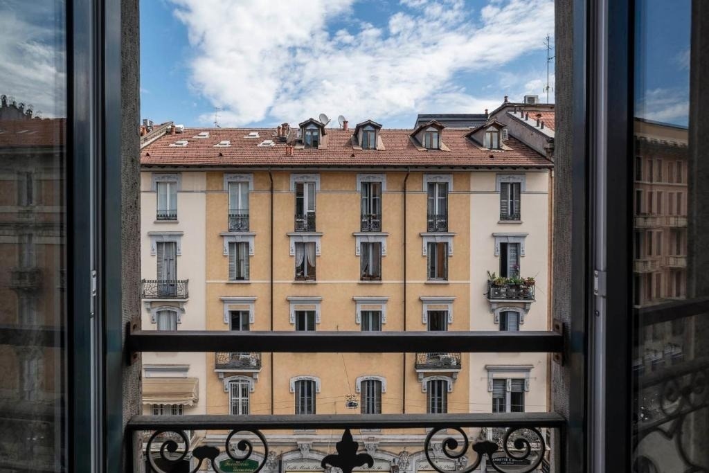 a view of a building from a balcony with a wrought iron railing