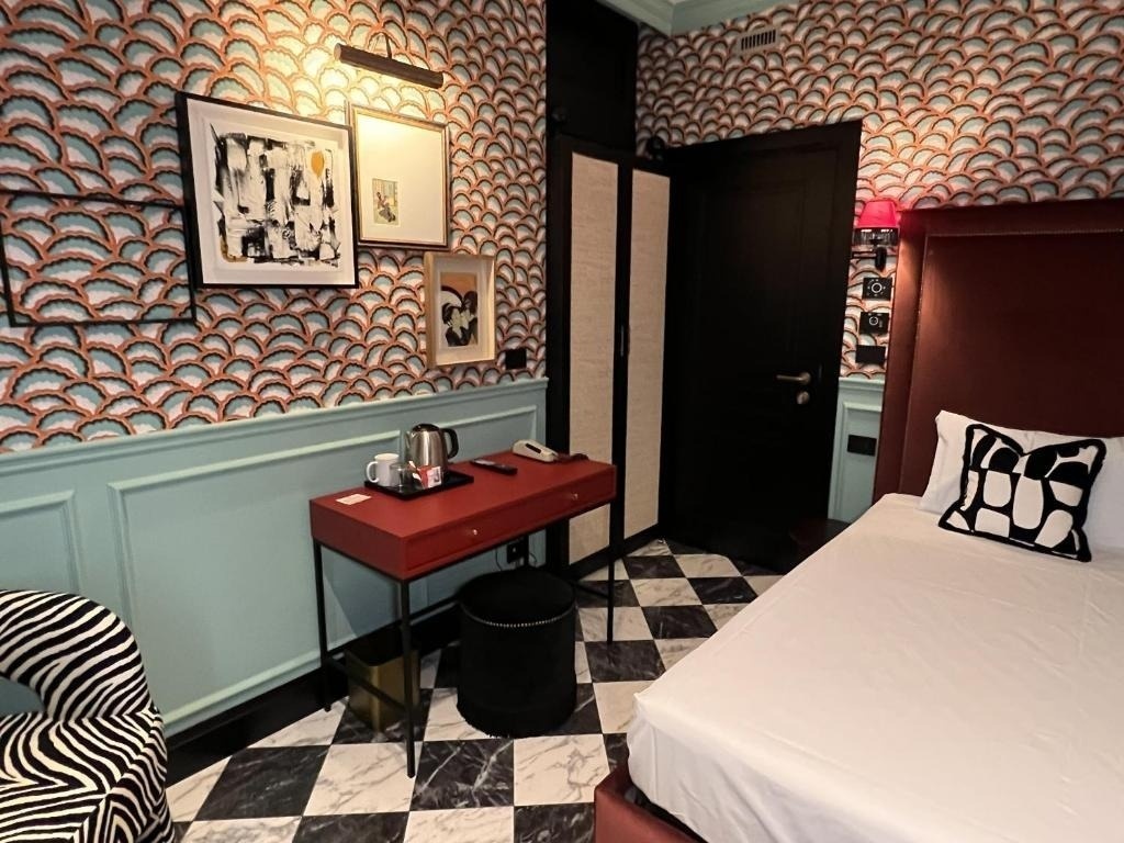 a hotel room with a bed and a desk