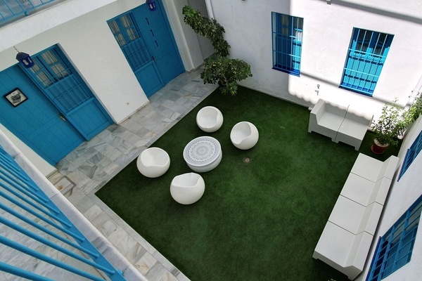 an aerial view of a courtyard with a table and chairs