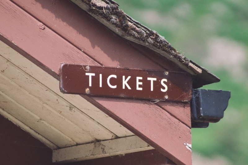 a sign on the side of a building that says tickets