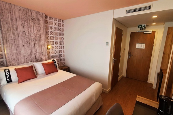 a hotel room with a bed and pillows that say soft