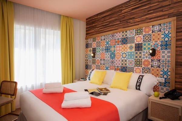 a hotel room with a bed that has a pillow that says soft on it
