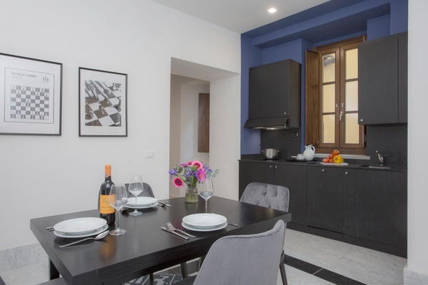 a bottle of wine sits on a table in a kitchen