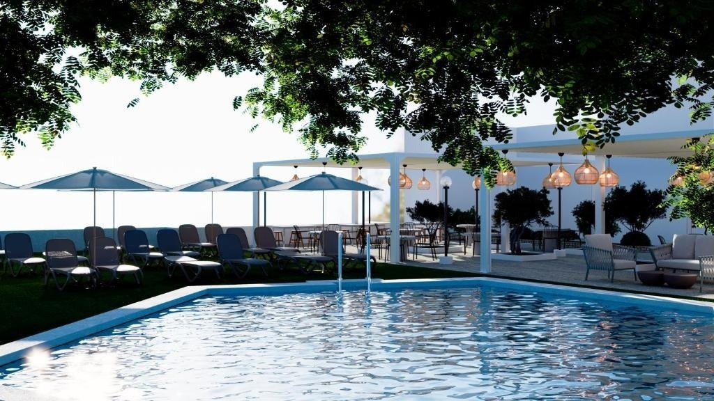 a large swimming pool surrounded by chairs and umbrellas