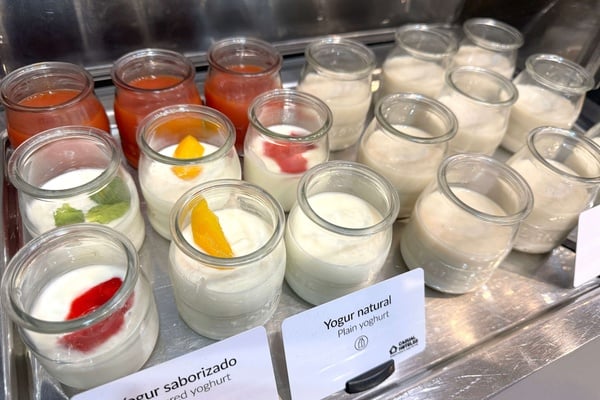 several jars of yogurt are lined up on a tray