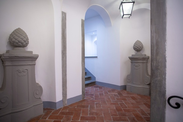 a hallway with a staircase in the background