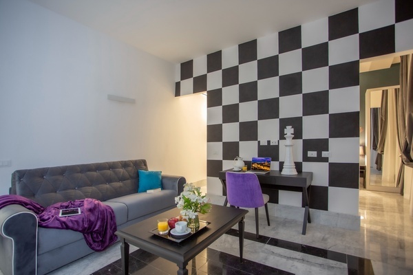 a living room with a black and white checkered wall