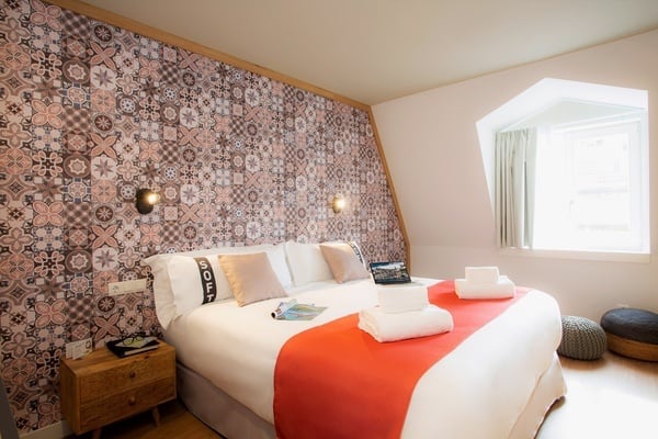 a hotel room with a bed and a laptop on it