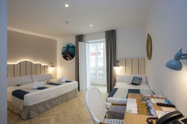 a hotel room with two beds and a desk