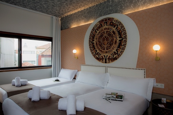 a hotel room with two beds and a mural on the wall