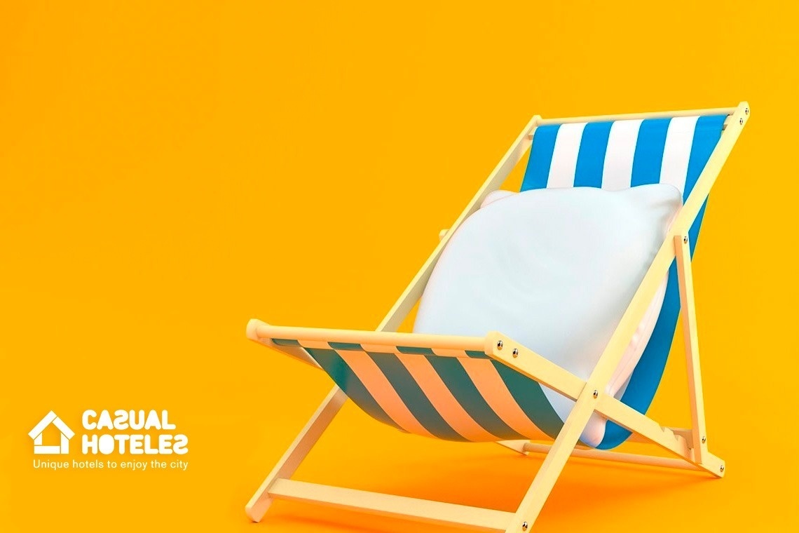 a blue and white striped beach chair on a yellow background