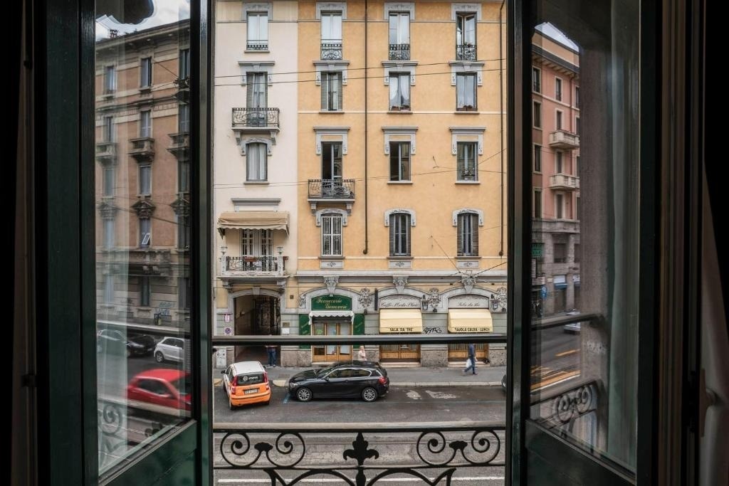 a car is parked in front of a building that says ' caffe ' on it