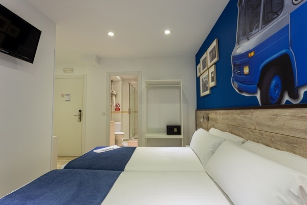 a hotel room with a blue van on the wall