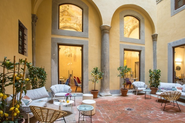 a courtyard with a lot of chairs and tables