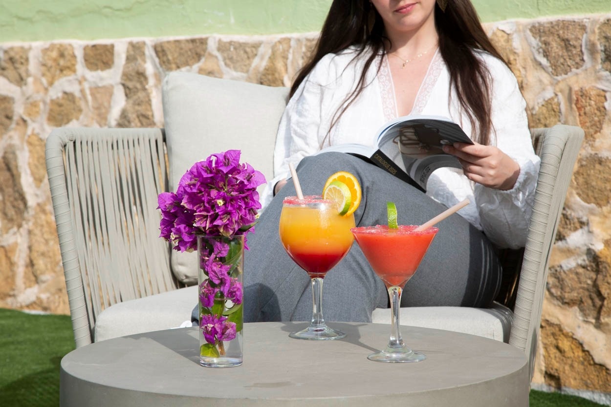 Détente au Casual Bahía Ibiza : cocktails fruités et lecture près de la plage, dans une ambiance décontractée.