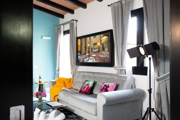 a living room with a couch and a television on the wall
