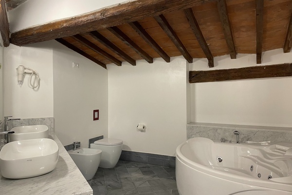 a bathroom with two sinks and a jacuzzi tub