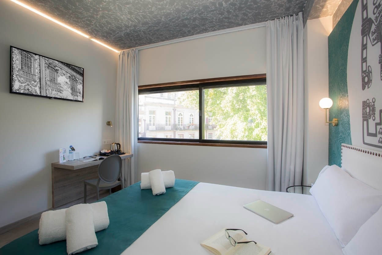 Modernes Zimmer mit Laptop und Buch: Casual Inca Porto - Zentrales Hotel in Porto