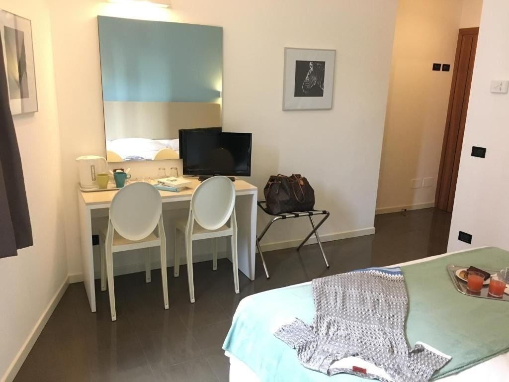 a hotel room with a desk and two chairs
