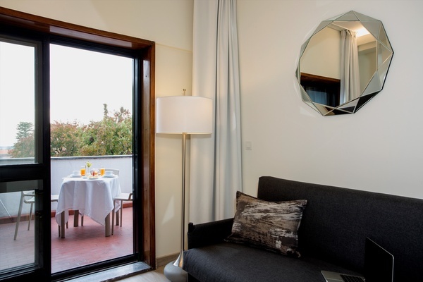 a room with a couch and a mirror on the wall