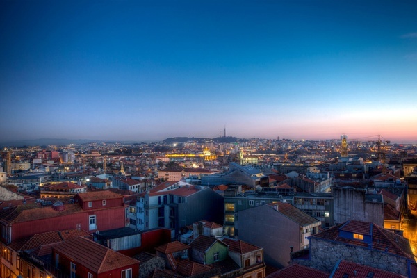 an aerial view of a city with a blue sky