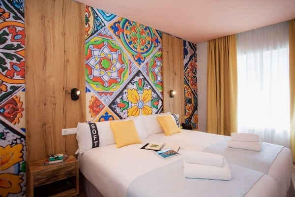 two beds in a hotel room with the word soft on the pillow