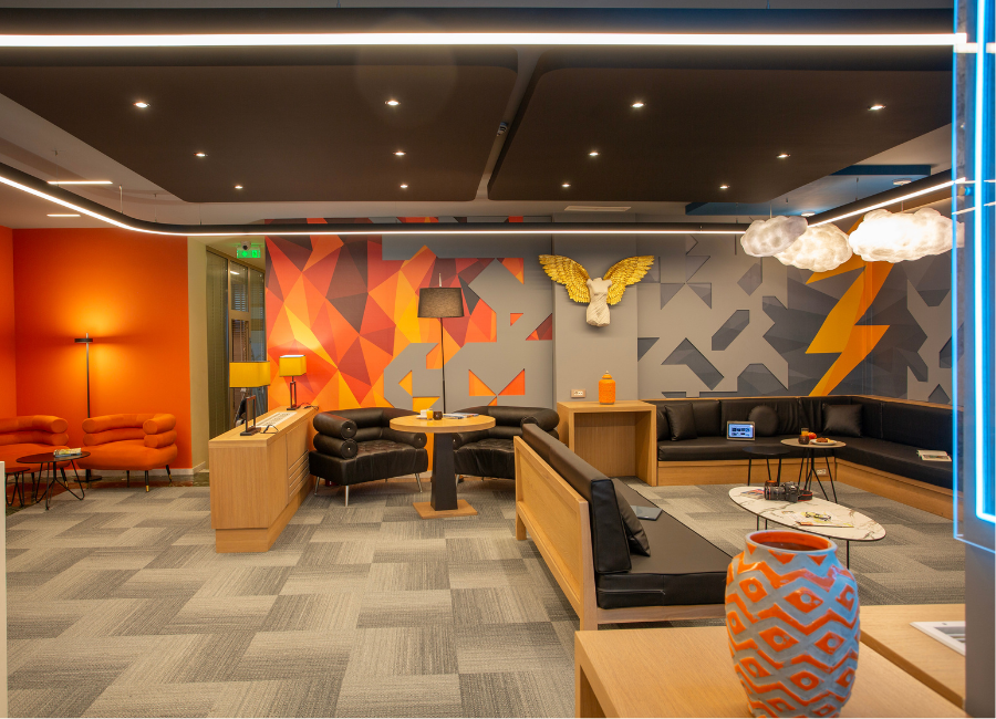 Modern hotel lounge with vibrant decor, comfortable seating, and eye-catching wall art.