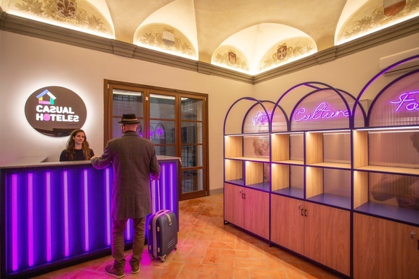 a man standing in front of a casual hotel reception desk