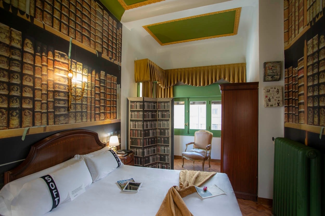 Bequemes Bett im Casual del Teatro Madrid - Stilvolles Zimmer mit Buchwand.
