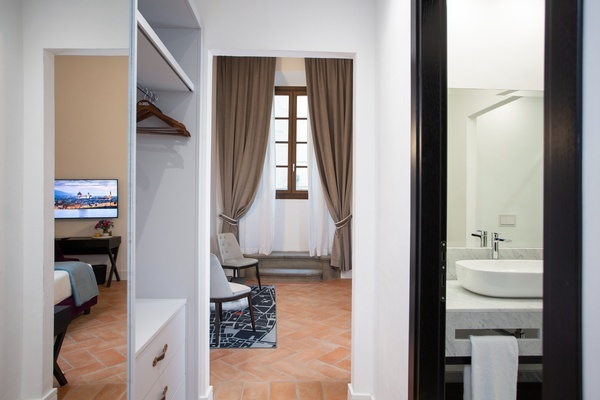 a bathroom with a sink and a flat screen tv