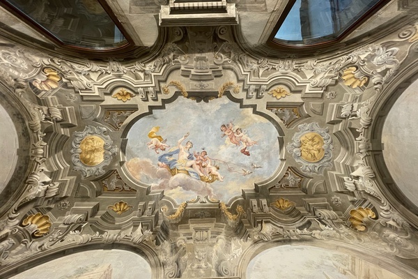 the ceiling of a building has a painting of angels on it