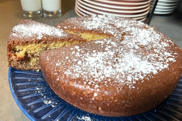 a cake with powdered sugar on it is on a blue plate