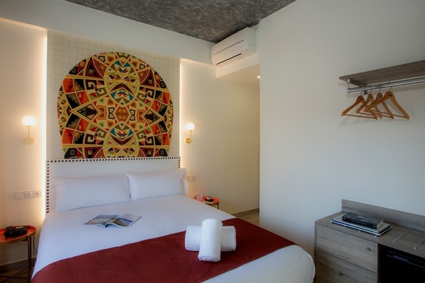 a bedroom with a bed and a painting on the wall