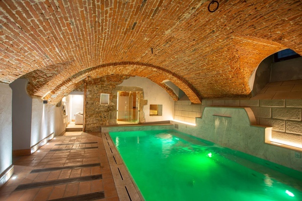 a large swimming pool with a brick ceiling
