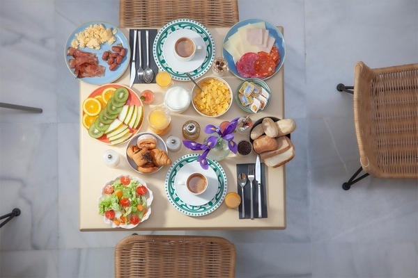 a table topped with plates of food and a cup of coffee