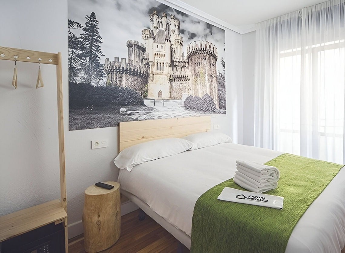 Charmantes Hotelzimmer im Casual Serantes Bilbao mit Schloss-Motiv an der Wand. Entspannen Sie in unserer offiziellen Unterkunft.