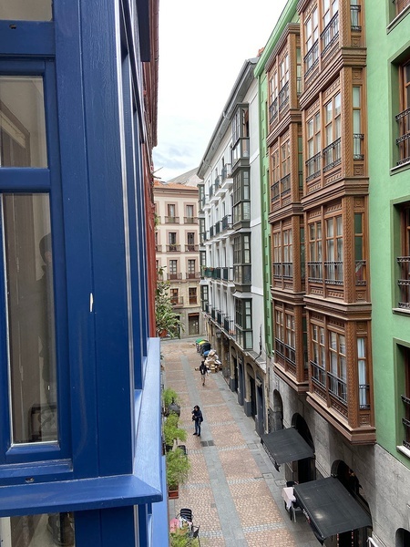 a view of a city street from a blue window