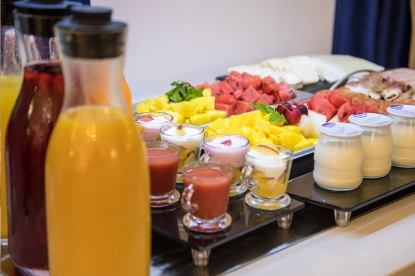una variedad de bebidas y frutas en un buffet