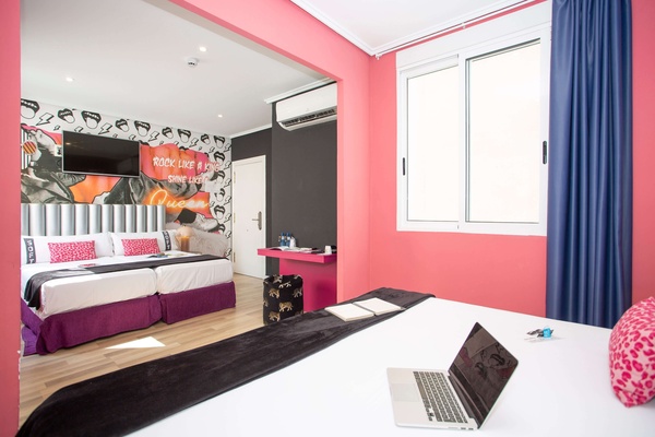 a hotel room with a sign on the wall that says rock like a girl