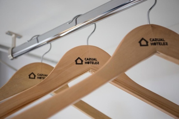 a row of wooden hangers with casual hotel2 written on them