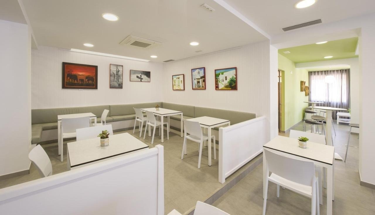 a dining room with tables and chairs and a picture on the wall that says barcelona