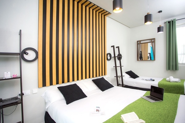 a hotel room with two beds and a laptop on the bed