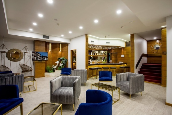 a hotel lobby with a bar and chairs