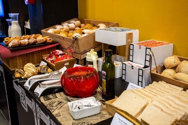 a buffet table with a bottle of heinz ketchup on it