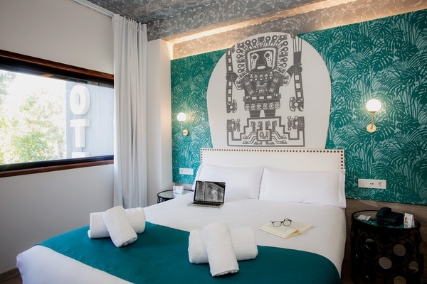 a hotel room with a bed and a laptop on it